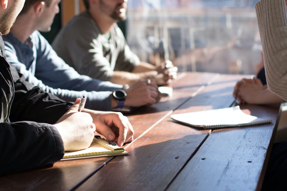 People sitting around a table in a meeting