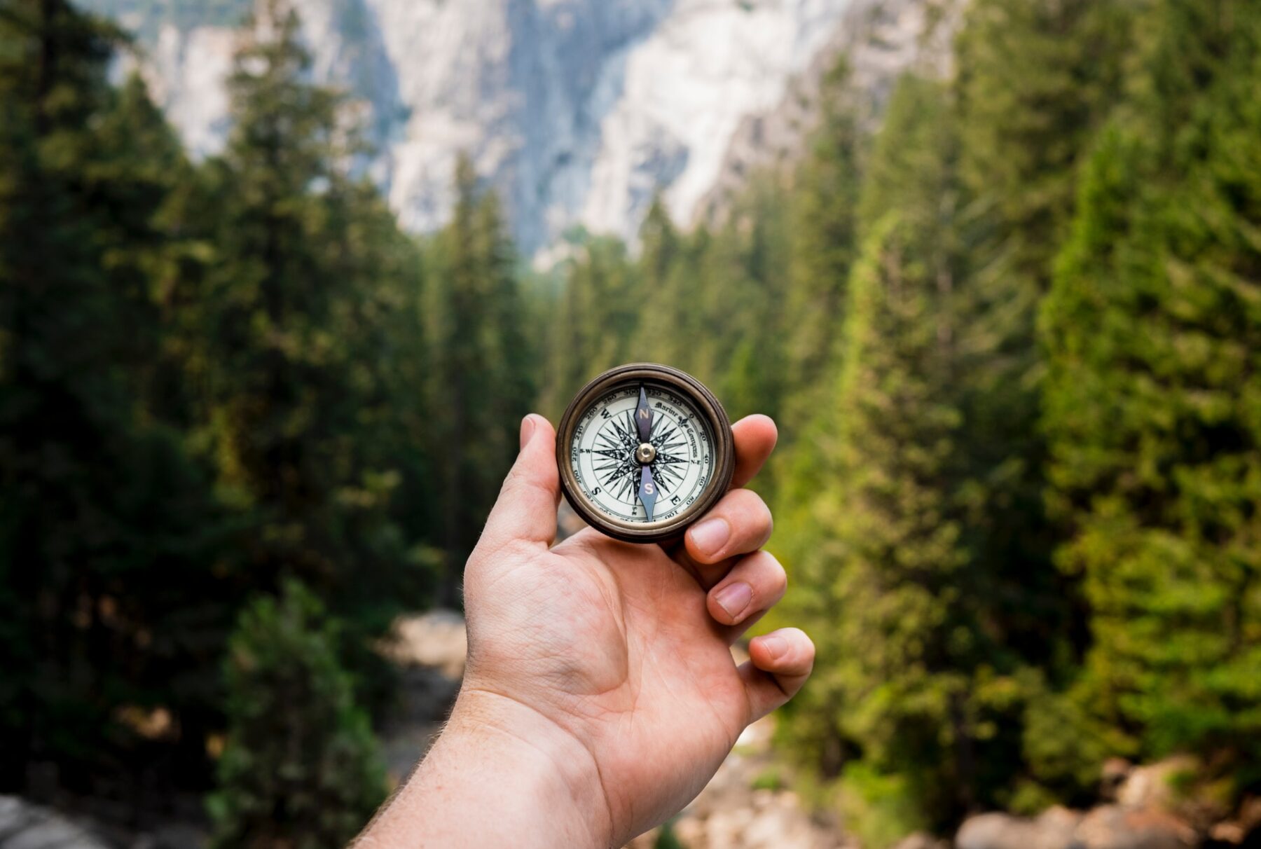 Image of a man holding a compass, an analogy for the foundation of building teams that thrive.